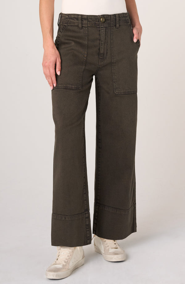 Front view of Mosswood Utility Relaxed Straight 28” Inseam pants by liverpool in dark olive worn with white sneakers