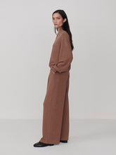 Woman wearing Varley Golden Bronze Marl The Extra Wide Leg Pant -29.5 with matching top in relaxed outfit by Varley