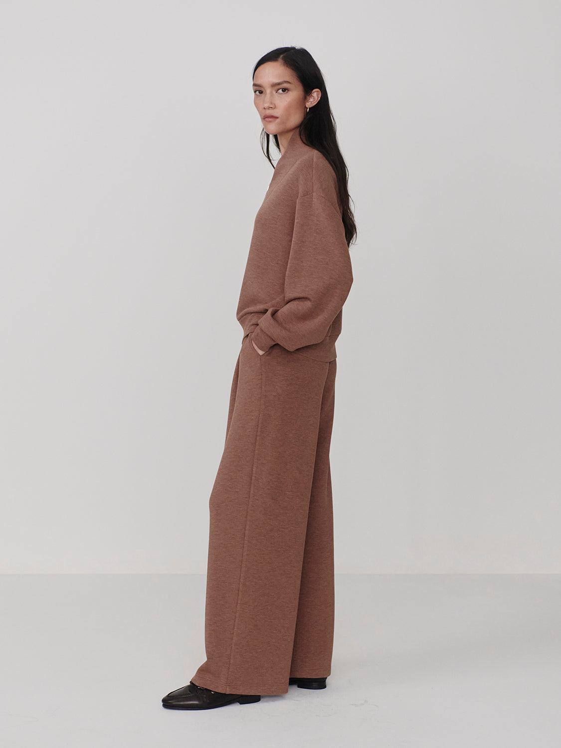Woman wearing Varley Golden Bronze Marl The Extra Wide Leg Pant -29.5 with matching top in relaxed outfit by Varley