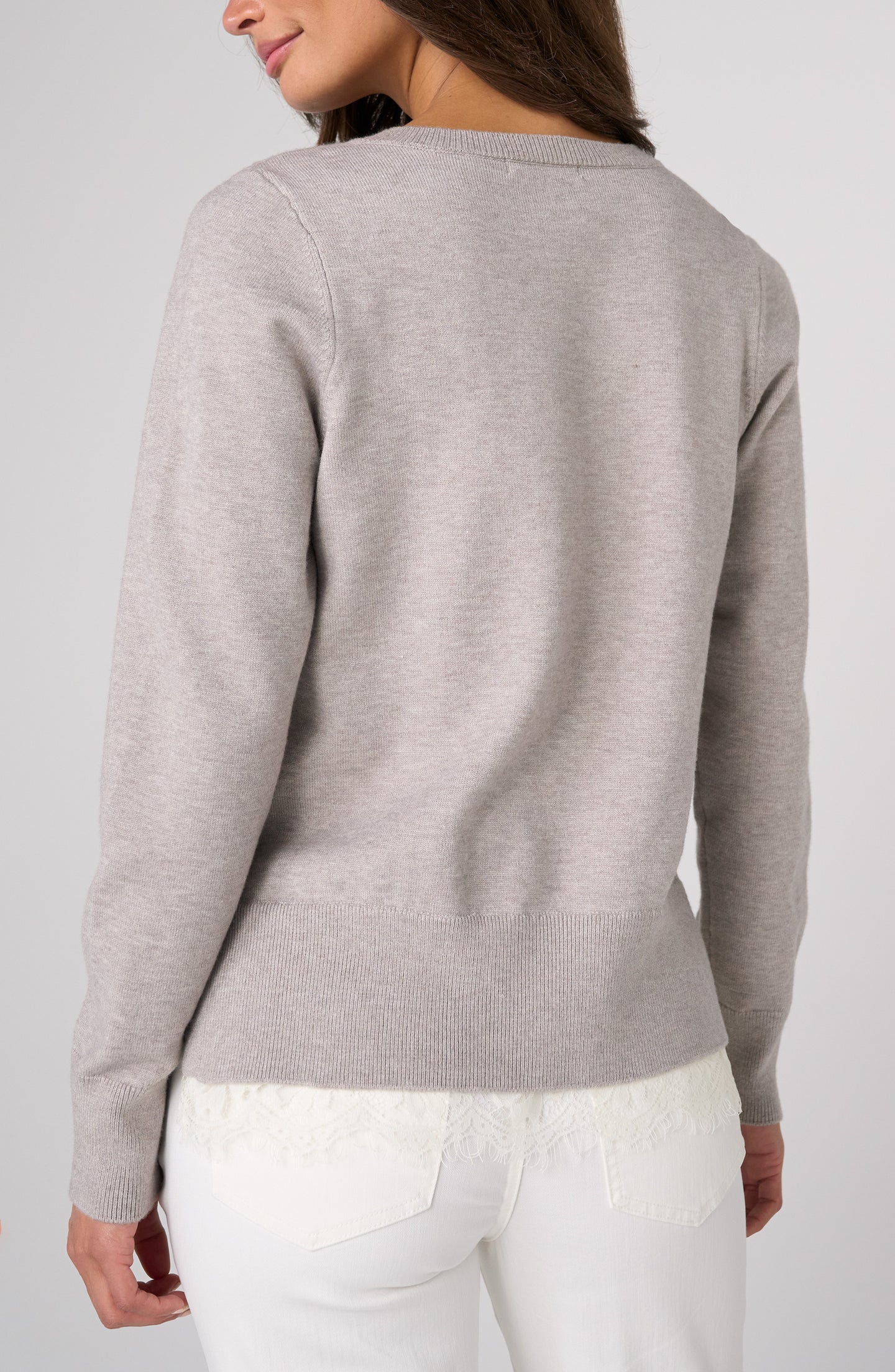 Back view of a woman wearing the Soft Grey Heather V Neck Long Sleeve Sweater with Lace Detail by liverpool