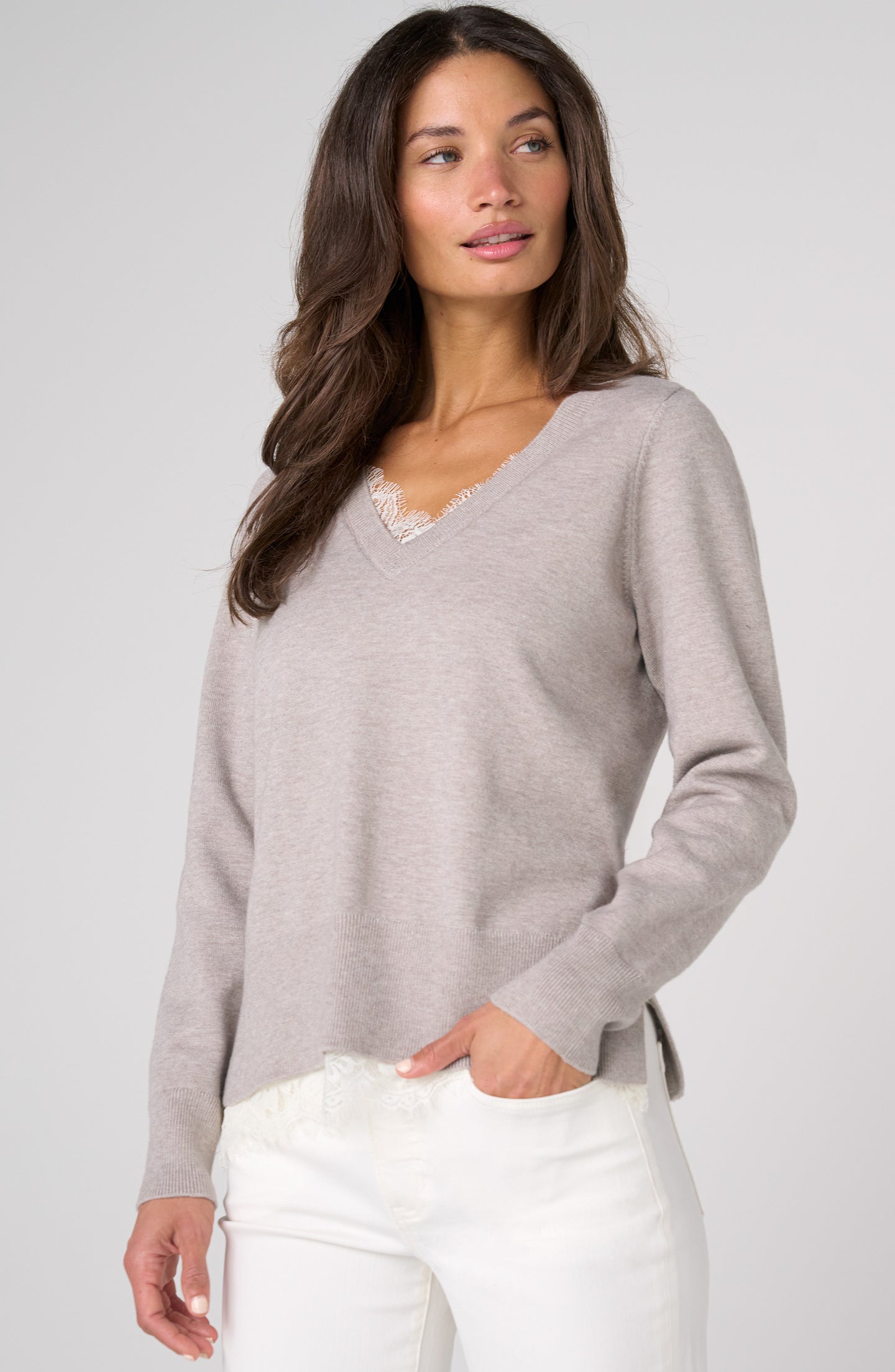 Woman wearing Soft Grey Heather V Neck Long Sleeve Sweater with Lace Detail by liverpool paired with white pants