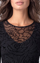 Close-up of a woman wearing Black Roses Layered Knit Top with V Detail showcasing sheer floral patterns from liverpool.