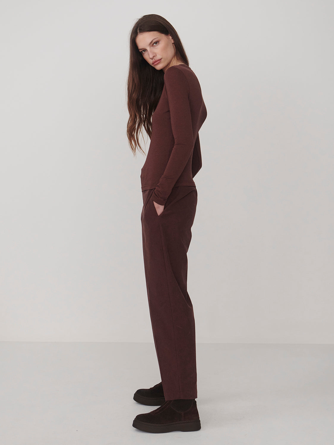 Varley Deep Mahogany Edna Long Sleeve Fitted Tee modeled with coordinating trousers