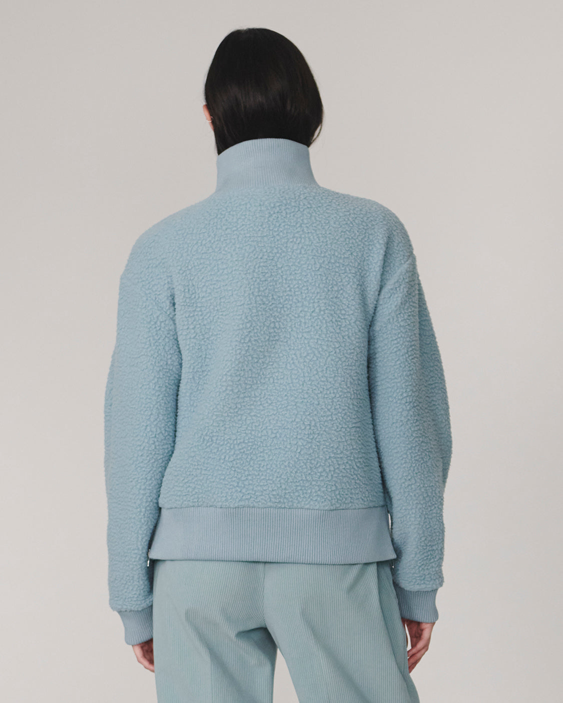 Varley Tourmaline Jaylin Half Zip Fleece in pale blue shown from the back