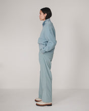 Varley Tourmaline Jaylin Half Zip Fleece in pale blue worn by a model in profile