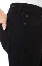 Close-up of black denim Black Rinse Liv Relaxed Skinny 28ins jeans by liverpool with hand in back pocket