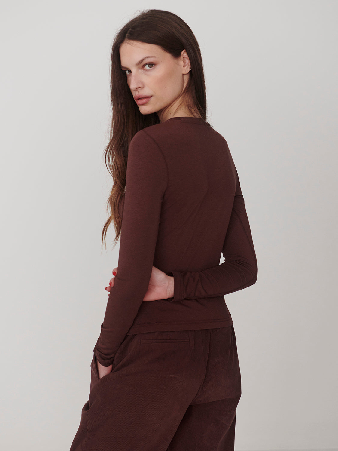 Deep Mahogany Edna Long Sleeve Fitted Tee by Varley worn by model in deep mahogany brown