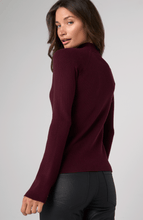 Woman wearing a ribbed Oxblood Turtleneck Sweater by liverpool, shown from the back with a slight turn to the side
