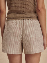 Close-up rear view of Birch Taupe Stripe Darina Short 4 in taupe stripes worn with a brown knit top by Varley
