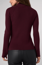 Back view of a woman wearing an Oxblood Turtleneck Sweater by liverpool with ribbed texture and fitted sleeves.