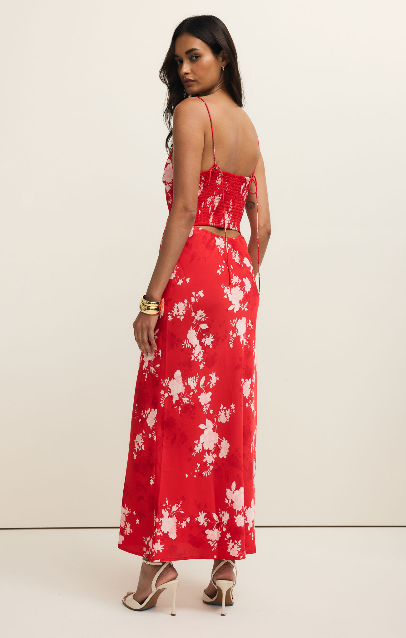Model wearing Kiss Me Red Alyse Darya Floral Maxi Dress by z supply with floral pattern and flowing silhouette from the back