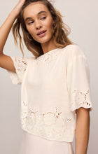 Model wearing White Daya Embroidered Top by z supply with floral cutout embroidery and short sleeves.