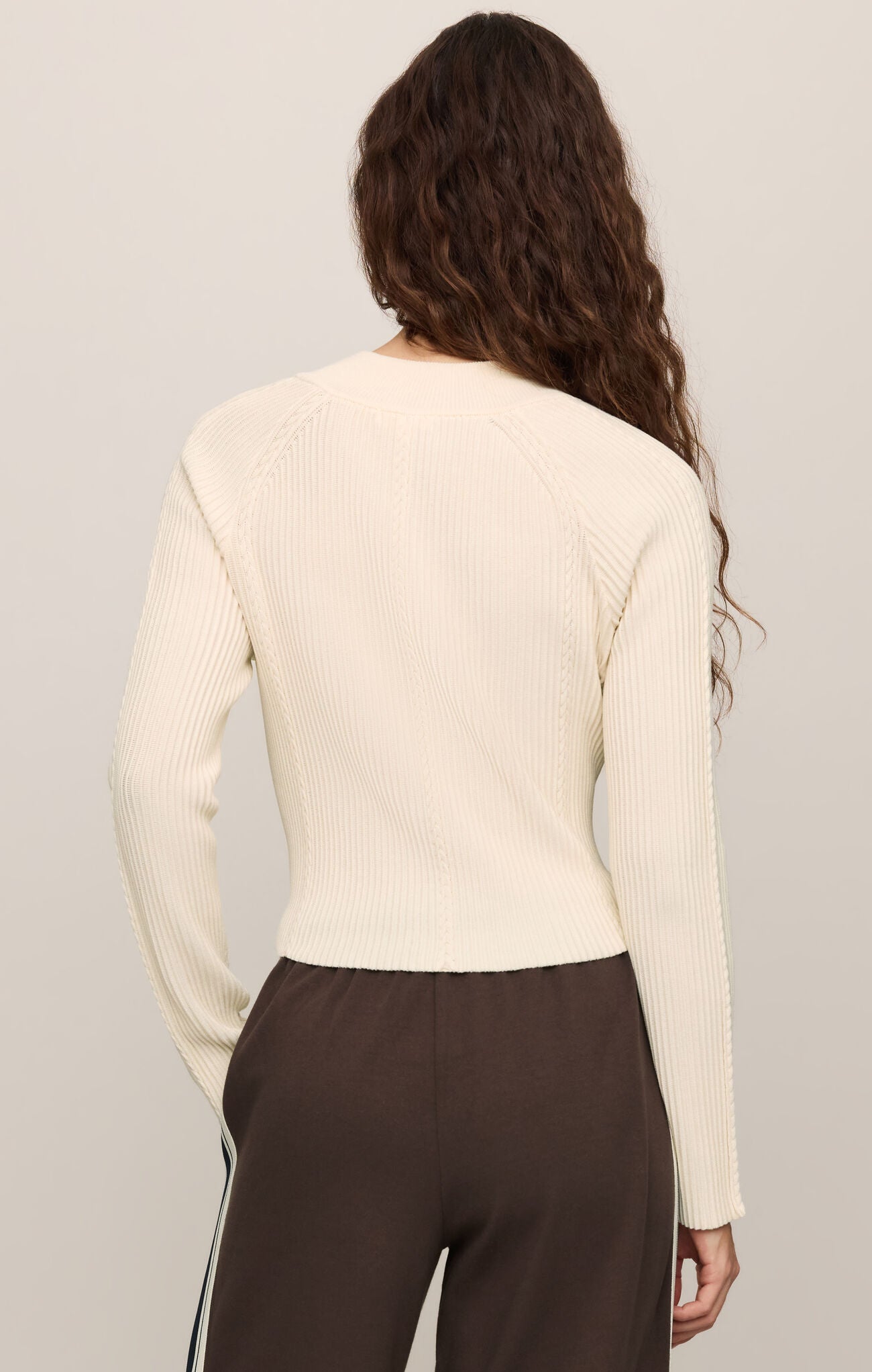 Back view of a woman wearing a cream Sandstone Summit Half Zip Sweater by z supply with long sleeves and ribbed texture