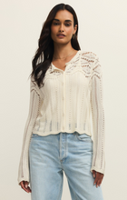 Woman wearing a white Cloud Alycia Crochet Sweater by z supply with delicate crochet details and button front closure