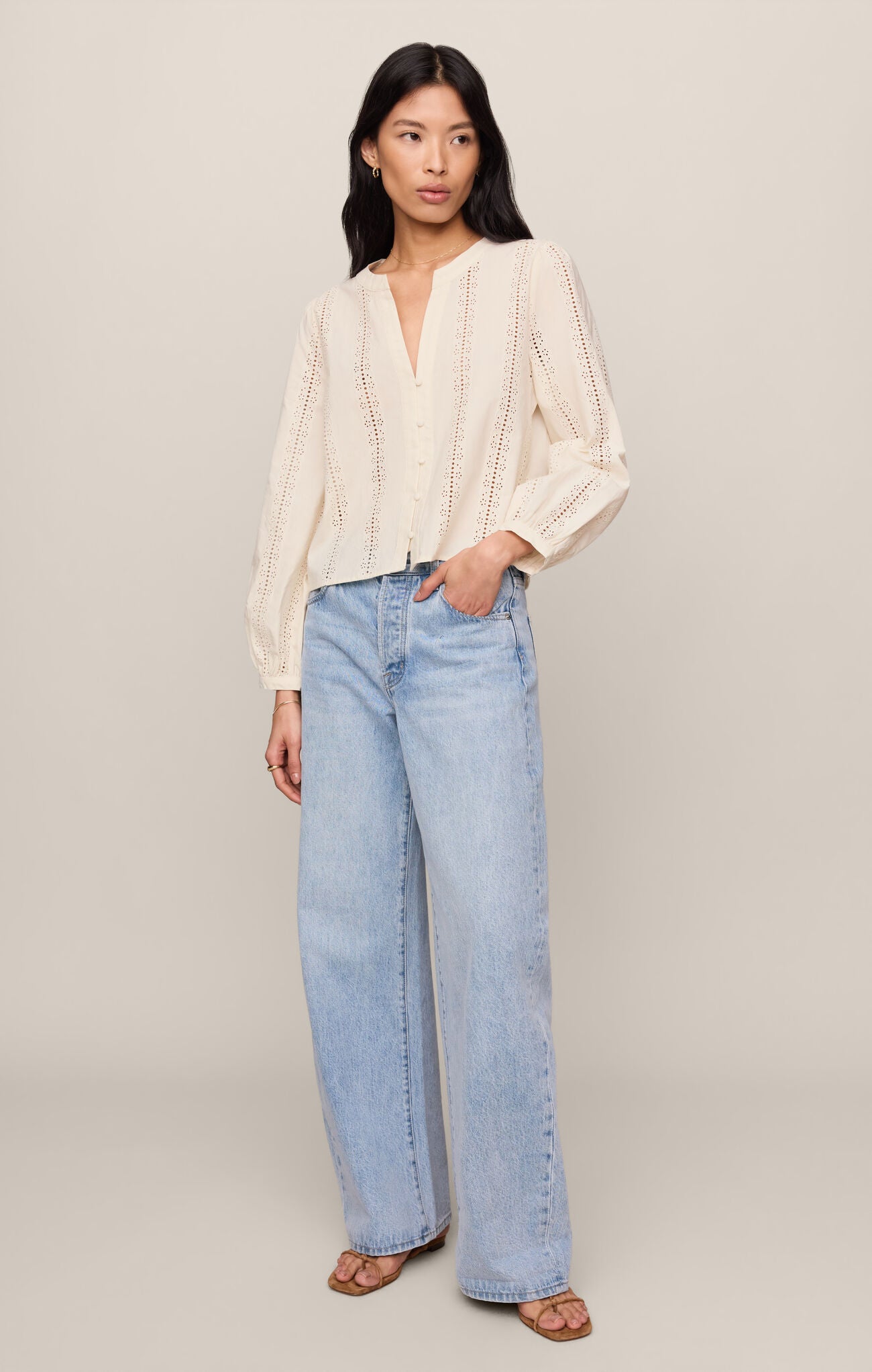 Woman wearing Cloud Louella Button Up Top by z supply in cream with light blue wide-leg jeans and sandals