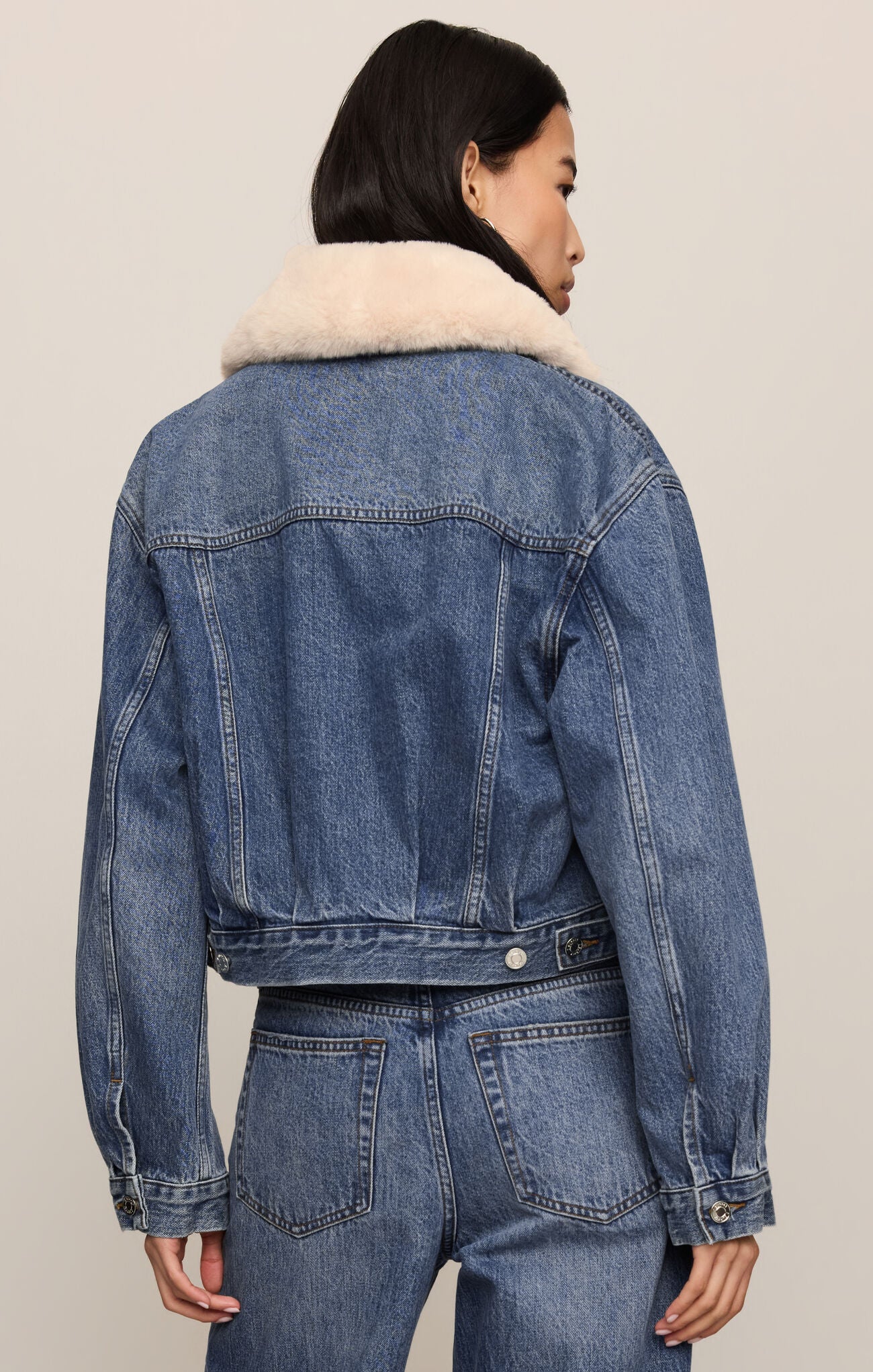 z supply Hush The Daily Denim Fur Jacket shown from the back with a cream sherpa collar and blue denim